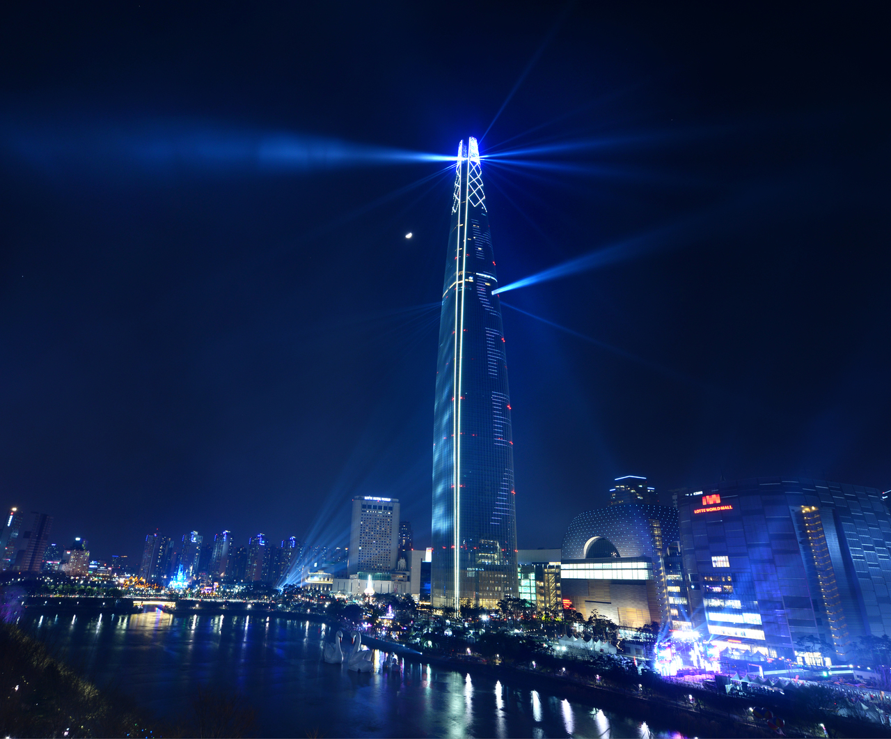 Lotte World Tower lit up at night above Seoul