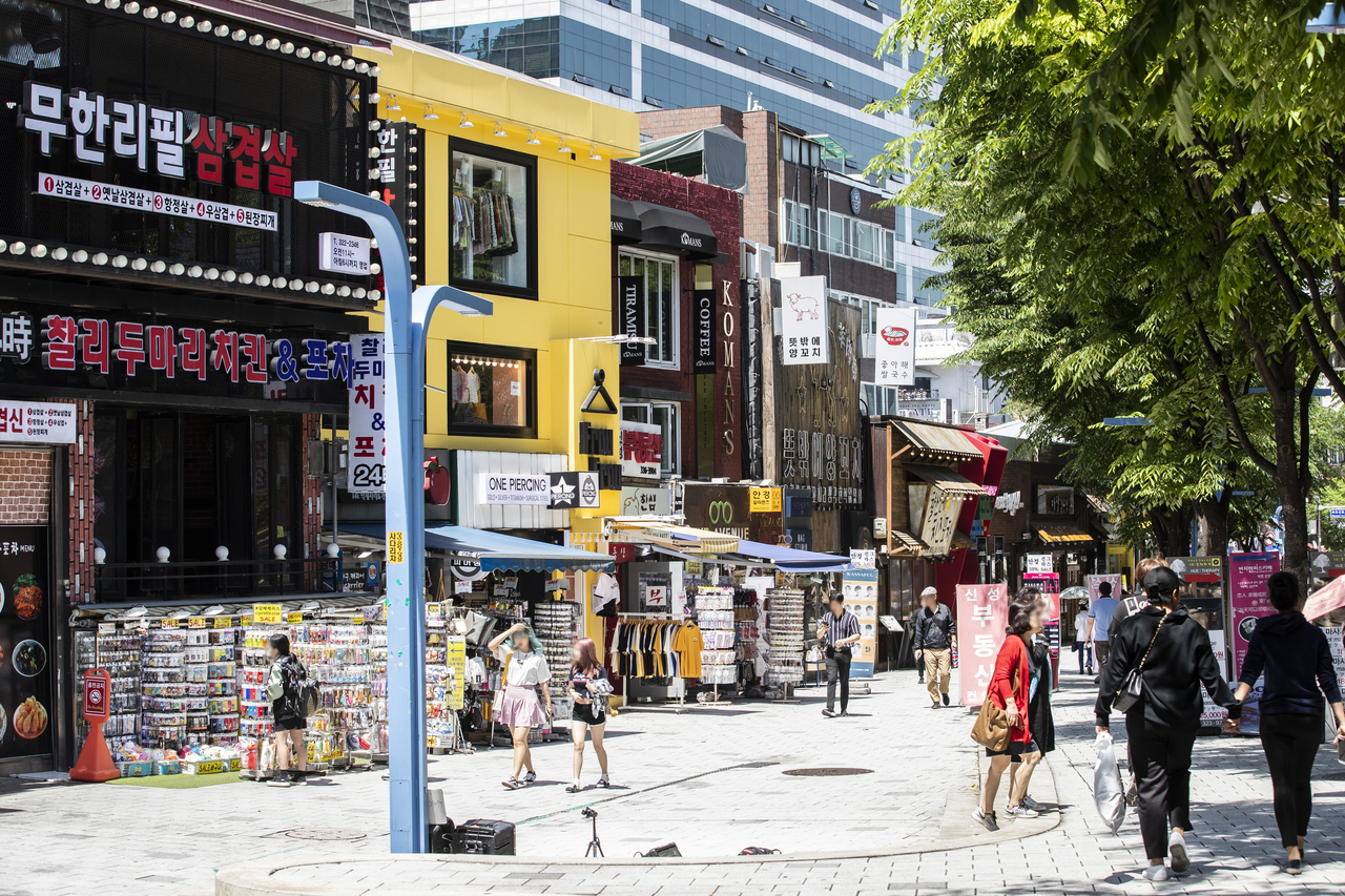 Shops and a busking spot on the Hongdae walking street