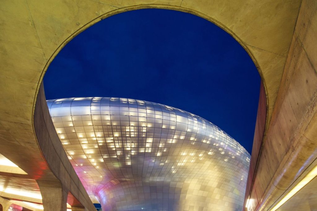 Dongdaemun Design Plaza glowing at night, Seoul's curved DDP landmark