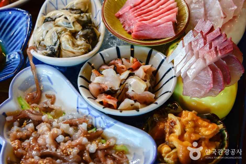 Korean seafood platter with sliced raw fish hoe and live octopus sannakji