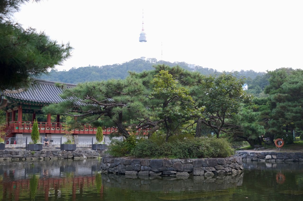 Garden pond and pavilion at Namsangol Hanok Village with N Seoul Tower