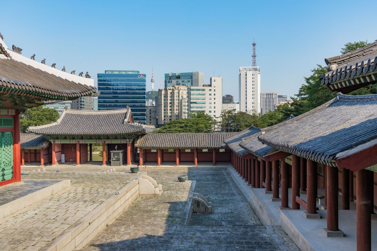 Gyeonghuigung Palace with the modern Seoul cityscape rising behind it
