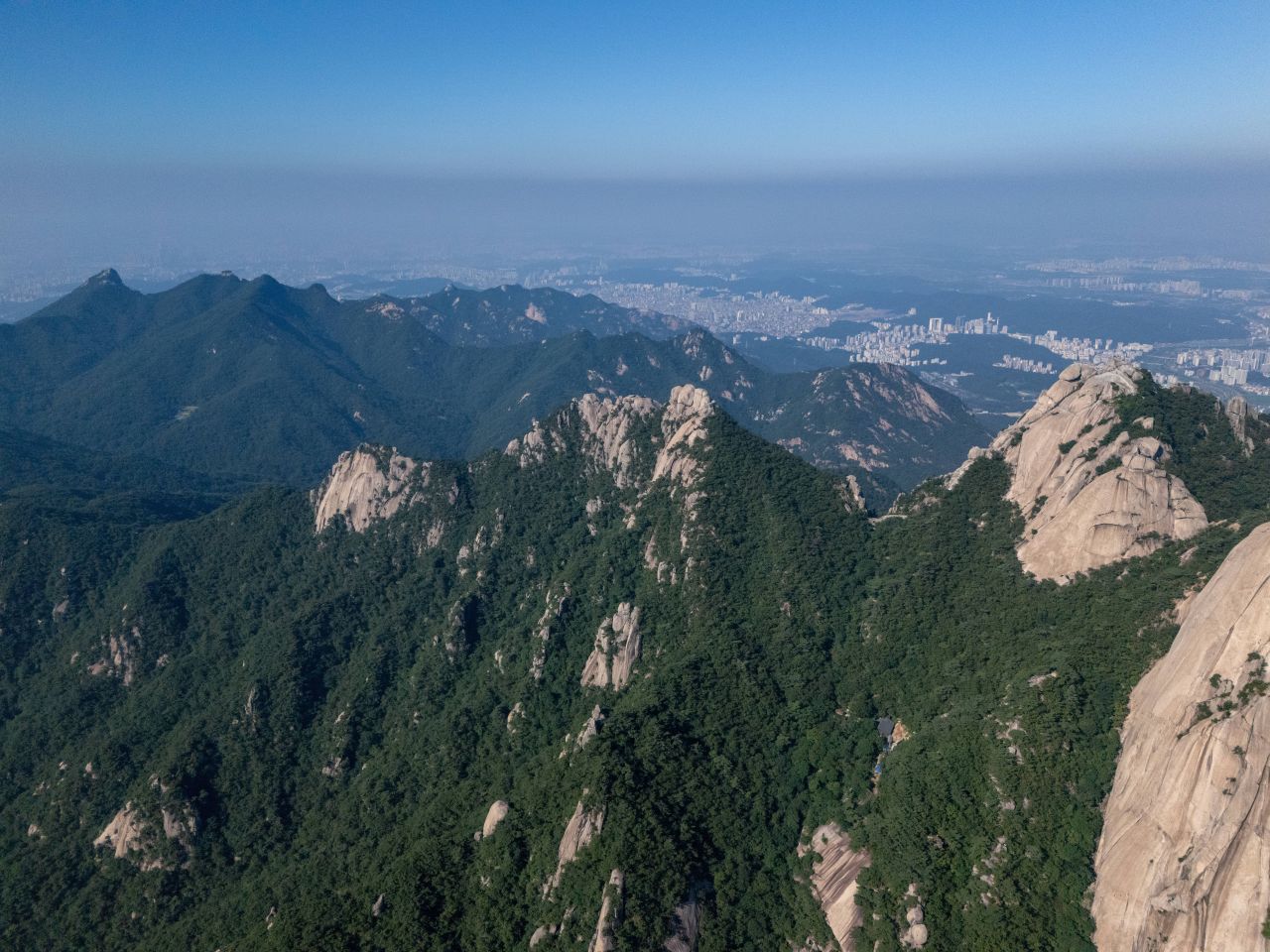 Granite ridgeline of Bukhansan National Park above the Seoul skyline