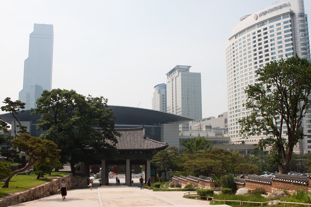 Bongeunsa Temple gate and pavilion with COEX skyscrapers behind in Gangnam, Seoul