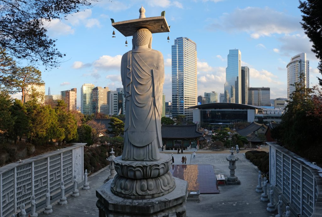 Bongeunsa Temple's Maitreya Buddha statue overlooking Gangnam skyscrapers in Seoul