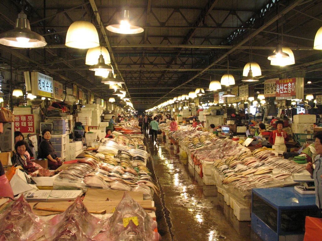 Long aisle of vendor stalls and fresh fish inside Noryangjin Fish Market hall, Seoul