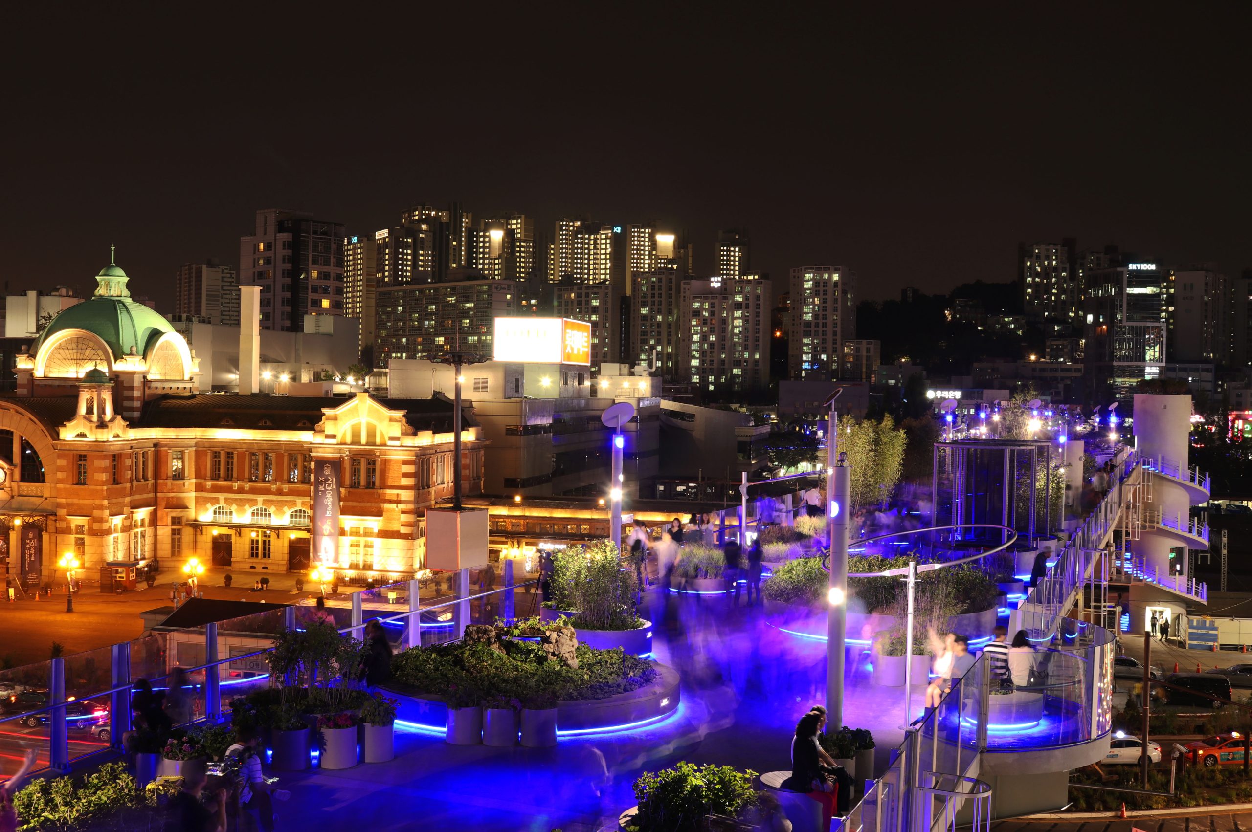 Blue LED lamps lighting the Seoullo 7017 deck after dark beside Culture Station Seoul 284