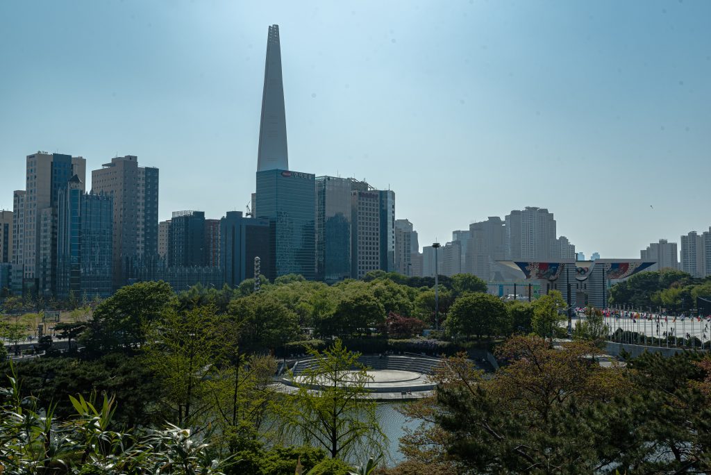 Olympic Park Seoul greenery with Lotte World Tower and Songpa skyline behind