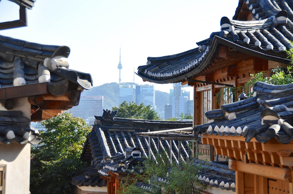 Cascading hanok tiled roofs in Bukchon with N Seoul Tower on Namsan behind