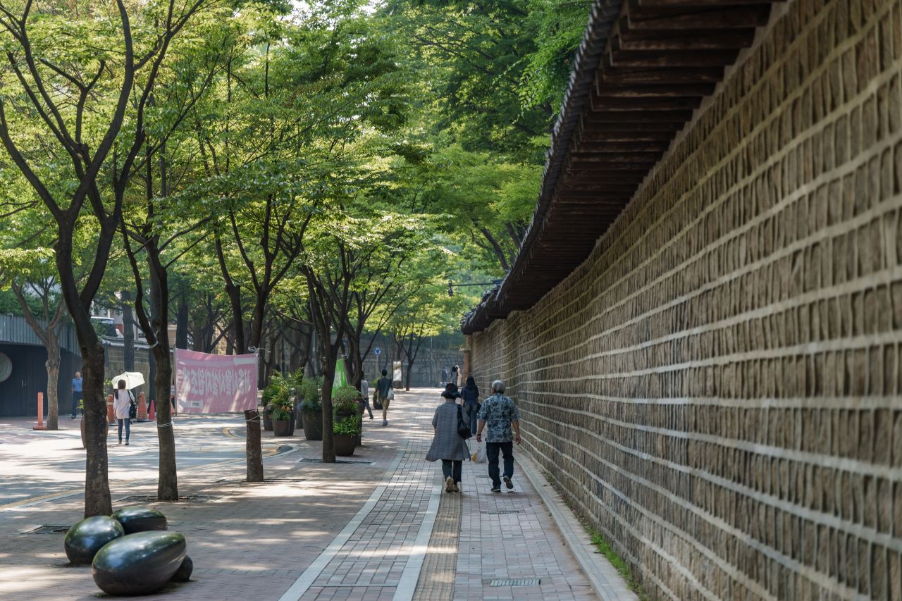 The tree-lined Deoksugung-gil stonewall walkway beside the palace wall, Seoul