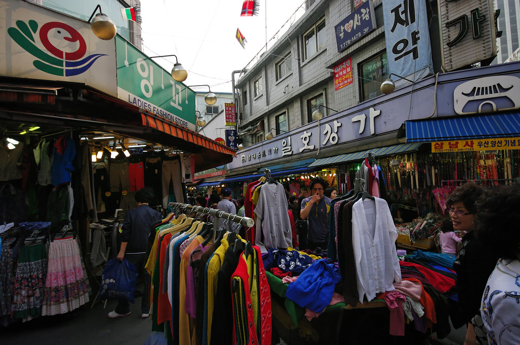 Colorful clothing stalls in a Namdaemun Market shopping alley in Seoul