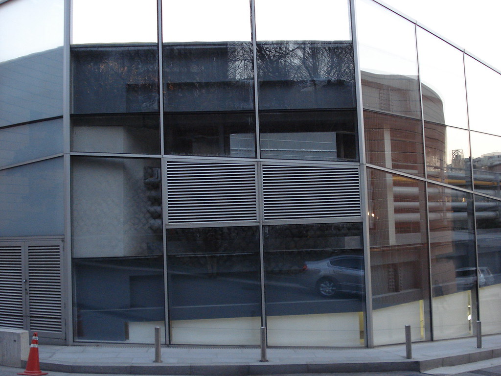 Leeum Museum glass facade with brick rotunda reflected