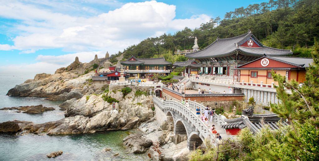 Haedong Yonggungsa temple halls and stone bridge on the sea rocks of Busan's east coast