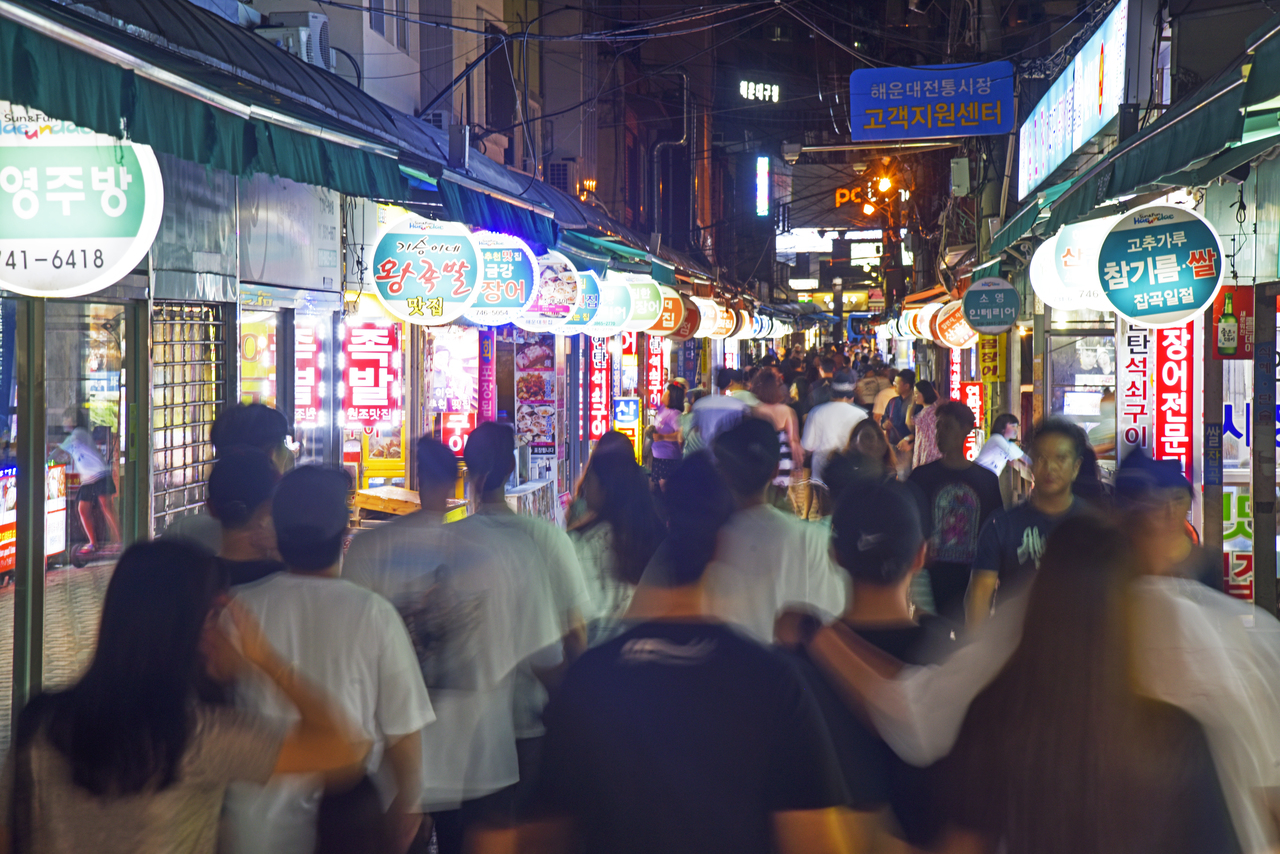 Busy food alley in Haeundae Traditional Market near Haeundae Beach at night