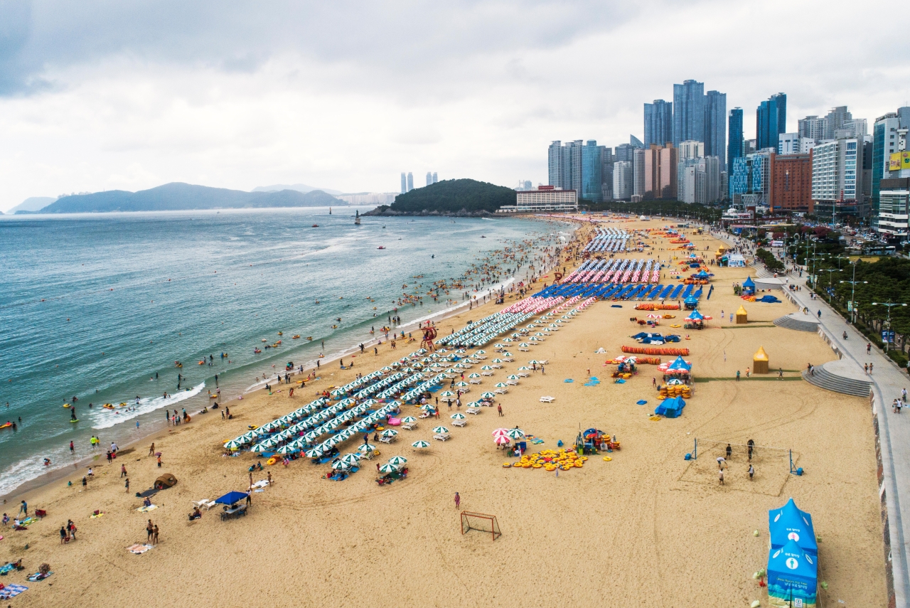 Haeundae Beach curving along the bay with Busan high-rise towers behind