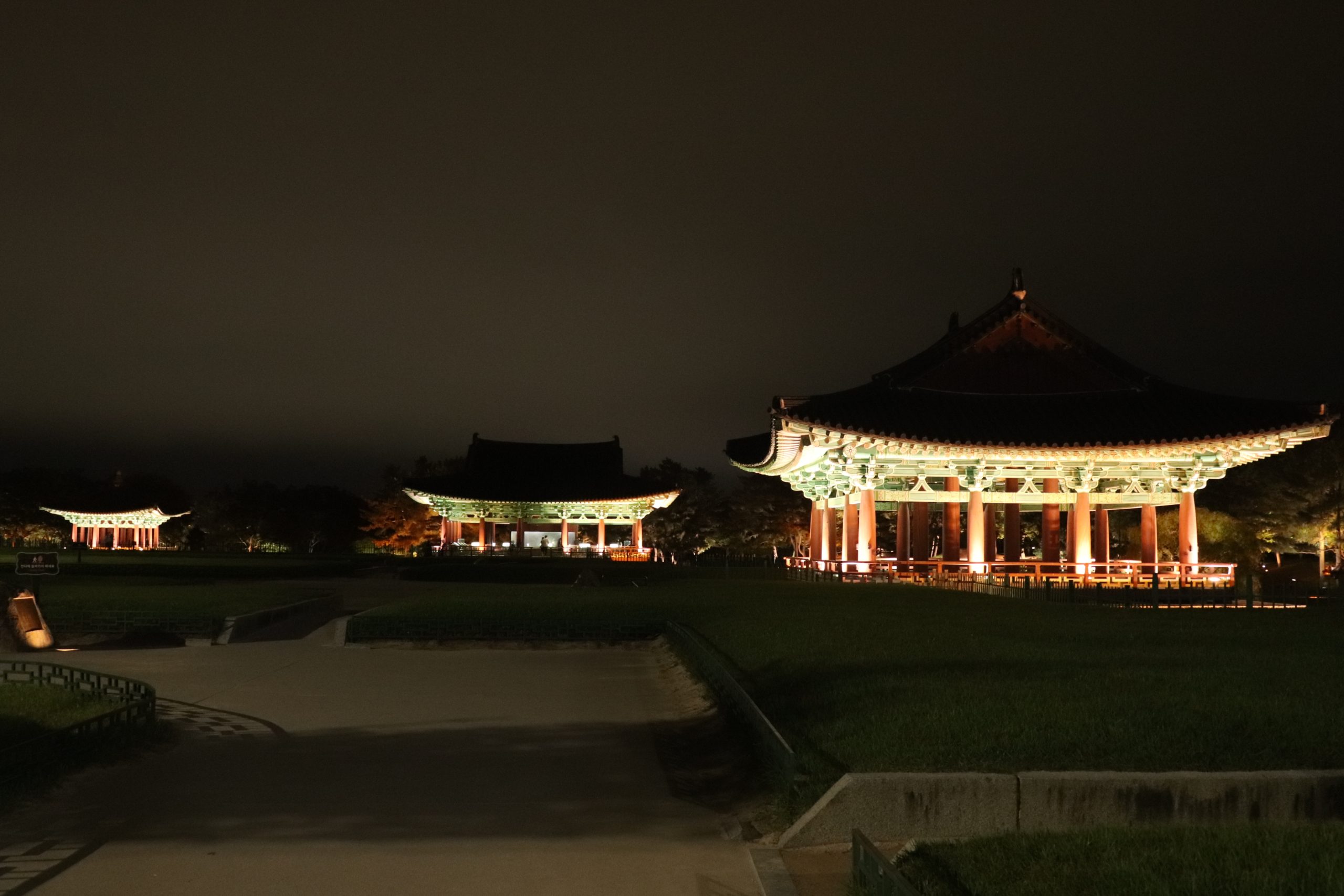 Three rebuilt pavilions lit at night at Wolji Pond in Gyeongju