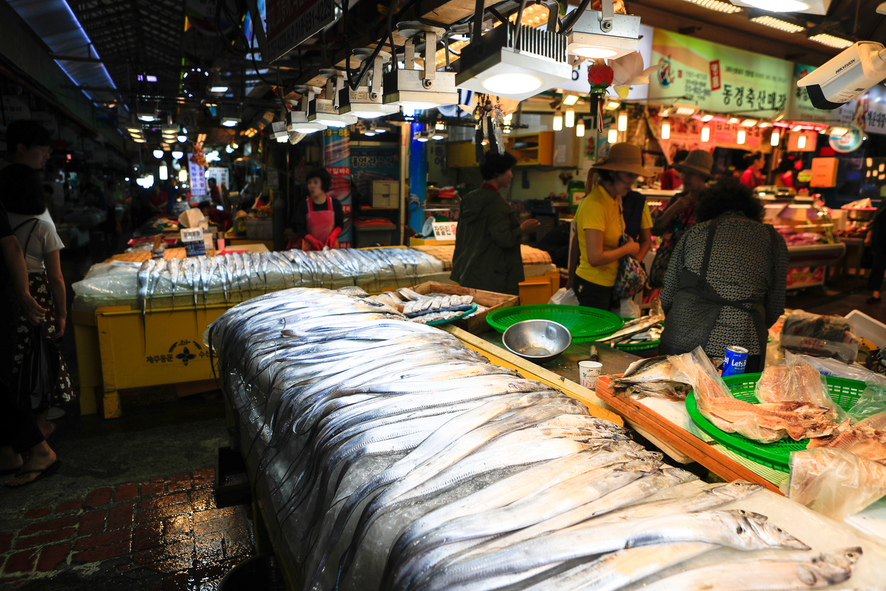 Silver hairtail fish laid out at a Dongmun Market seafood stall, Jeju