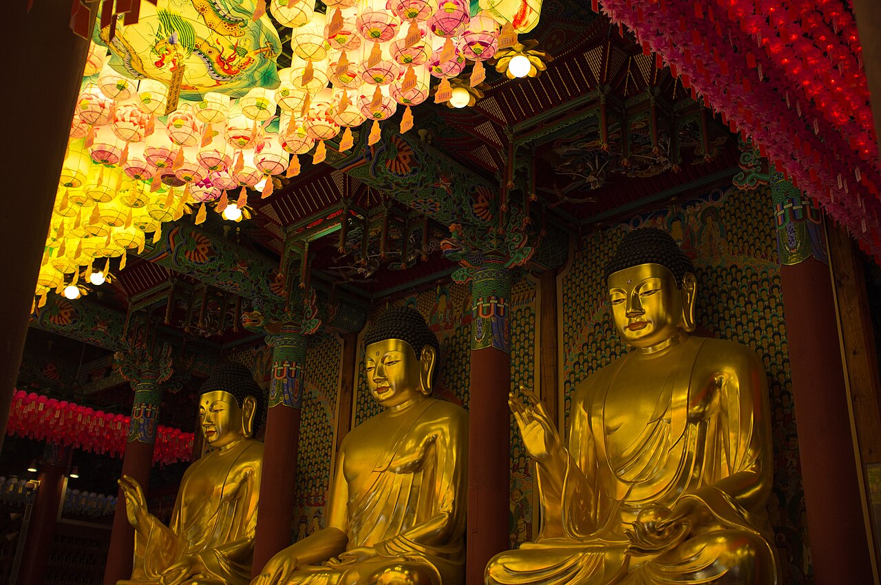 Three gilded Buddha statues inside Jogyesa Temple main hall